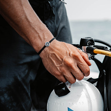 The 4ocean Osborne Reef Bracelet is worn by a male Scubadiver.