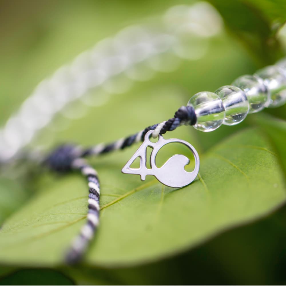 4ocean Great White Shark Beaded Bracelet close-up on a leaf