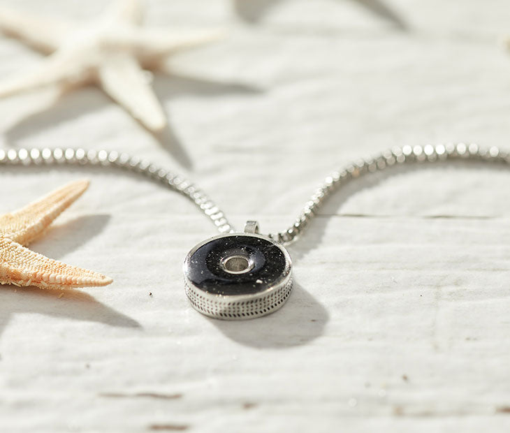 This 18” box chain necklace is made from recycled stainless steel. Designed to represent the tires we’re recovering from the Osborne Reef, the tire-shaped pendant is filled with verified 100% crumb rubber from tires that our crews recovered directly from the Osborne Reef.