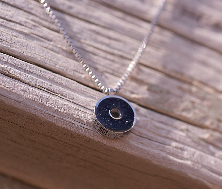 This 18” box chain necklace is made from recycled stainless steel. Designed to represent the tires we’re recovering from the Osborne Reef, the tire-shaped pendant is filled with verified 100% crumb rubber from tires that our crews recovered directly from the Osborne Reef.