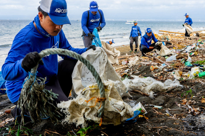 4ocean worker removing trash from the beach.