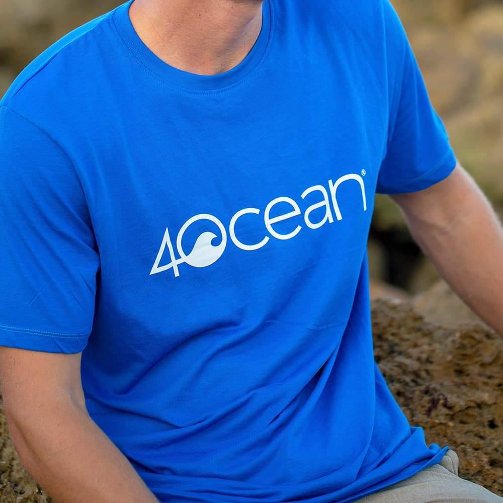 4ocean logo unisex men's and women's t-shirt on a man - blue