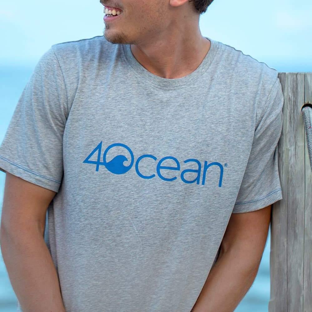 4ocean logo unisex men's and women's t-shirt on a man - grey