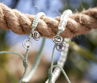 Olive Ridley Sea Turtle Beaded and Braided Bracelets looped over a rope