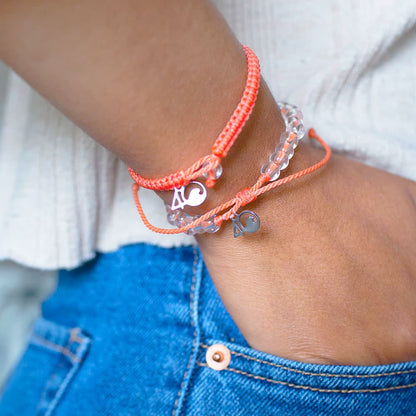 Closeup of a Person Wearing the 4ocean Albatross Beaded and Braided Bracelet 2-Pound Pack