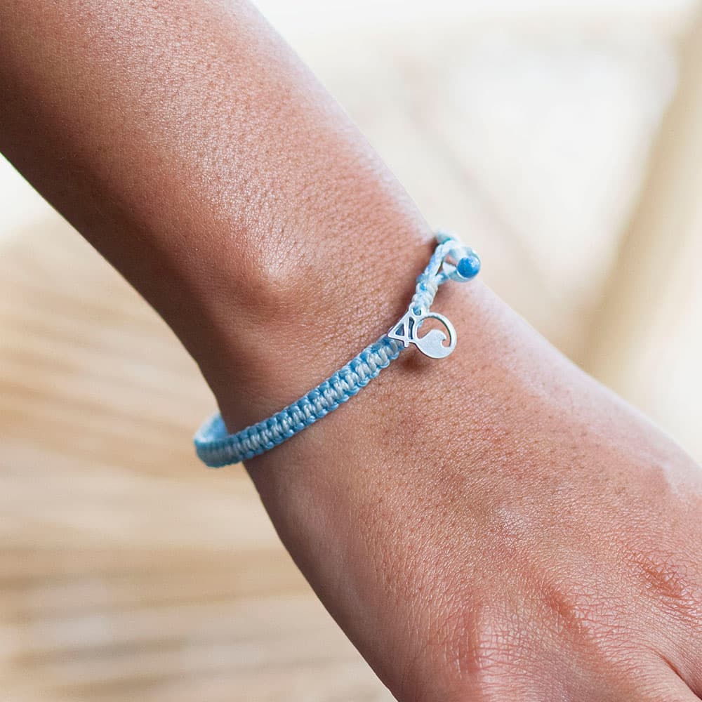 A Person Wearing the 4ocean Beluga Whale Braided Bracelet