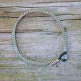 4ocean Plankton Braided Bracelet on a Wooden Plank