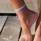 4cean Braided Anklet - blue. On ankle with 3 other 4ocean braided anklets.