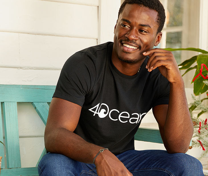4ocean logo unisex men's and women's t-shirt on a man - black