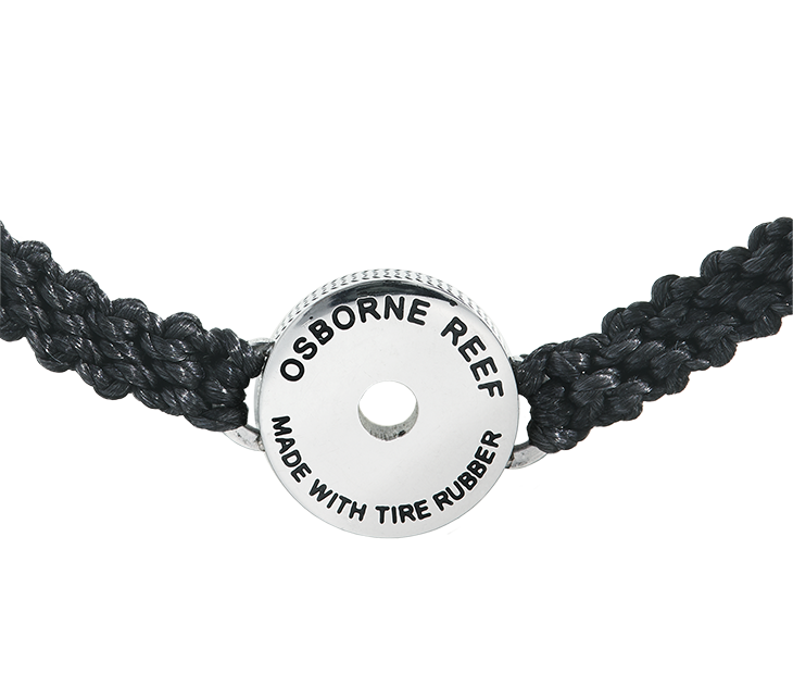 This black macrame bracelet is hand braided using 100% recycled plastic cord. Designed to represent the tires we’re recovering from the Osborne Reef, the tire-shaped bezel is filled with verified 100% crumb rubber from tires that our crews recovered directly from the Osborne Reef.