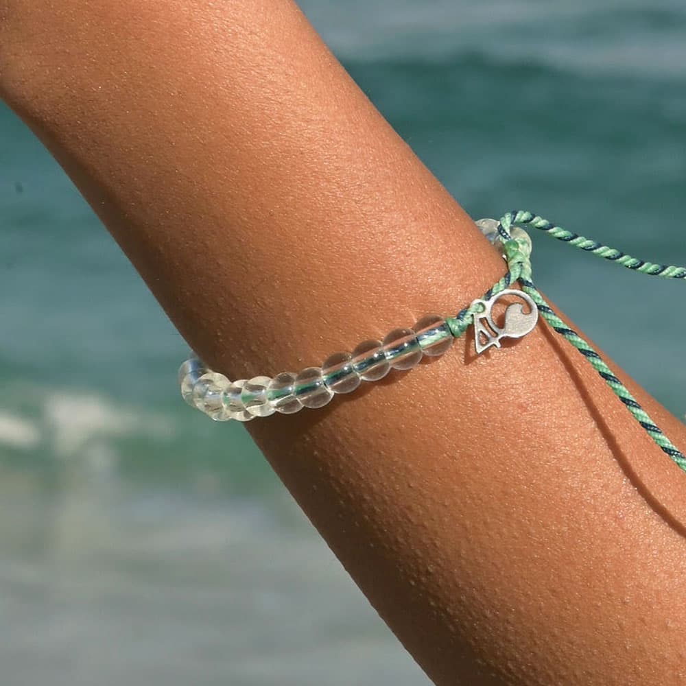 A woman wearing the 4ocean Stingray Limited Edition Beaded Bracelet