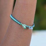 A closeup of a person wearing the 4ocean Stingray Limited Edition Braided Bracelet