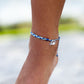 4ocean Blue Multicolor Braided Anklet. On ankle of female model.