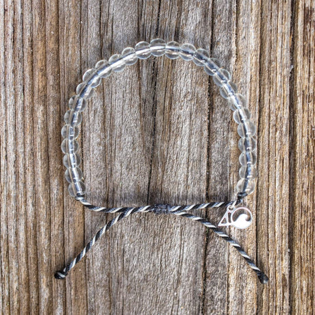 4ocean Great White Shark Beaded Bracelet on a wood plank