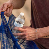 4ocean Polar Bear Beaded Bracelet on a man's wrist