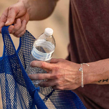 4ocean Polar Bear Beaded Bracelet on a man's wrist