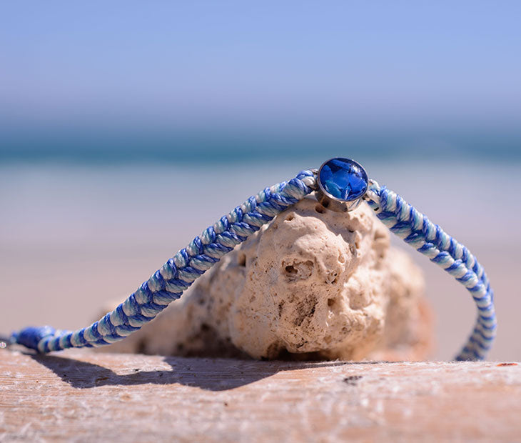 4ocean Blue Ocean Drop bracelet. Blue and white braided cord with stainless and blue bezel.
