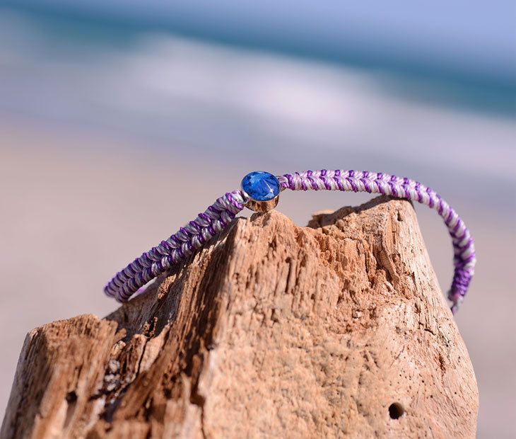4ocean Purple Ocean Drop Bracelet. Purple braided cord with stainless and blue bezel. 