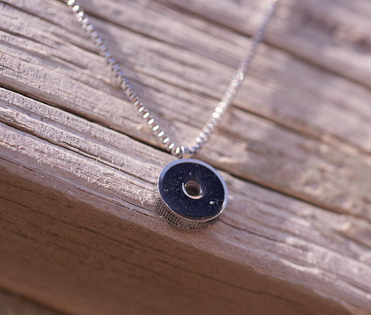 This 18” box chain necklace is made from recycled stainless steel. Designed to represent the tires we’re recovering from the Osborne Reef, the tire-shaped pendant is filled with verified 100% crumb rubber from tires that our crews recovered directly from the Osborne Reef. 