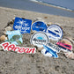 Collection of stickers in the sand on the beach