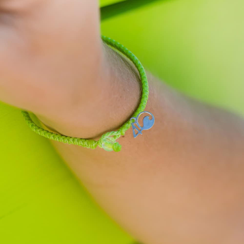 4ocean Sea Turtle Braided Bracelet on a wrist