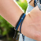 Shark Stack Bracelet being modeled on a female who's clutching onto the belt loop of her jeans