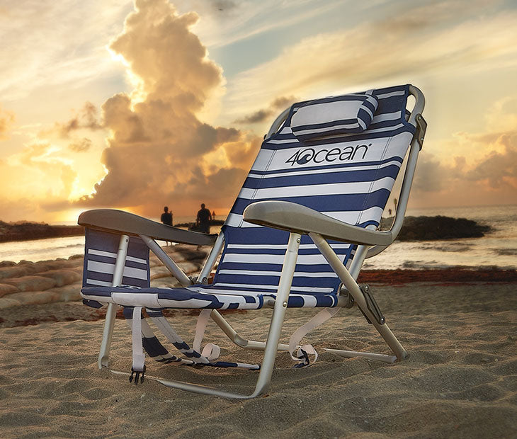 Striped 4ocean beach chair on the beach with the sunset