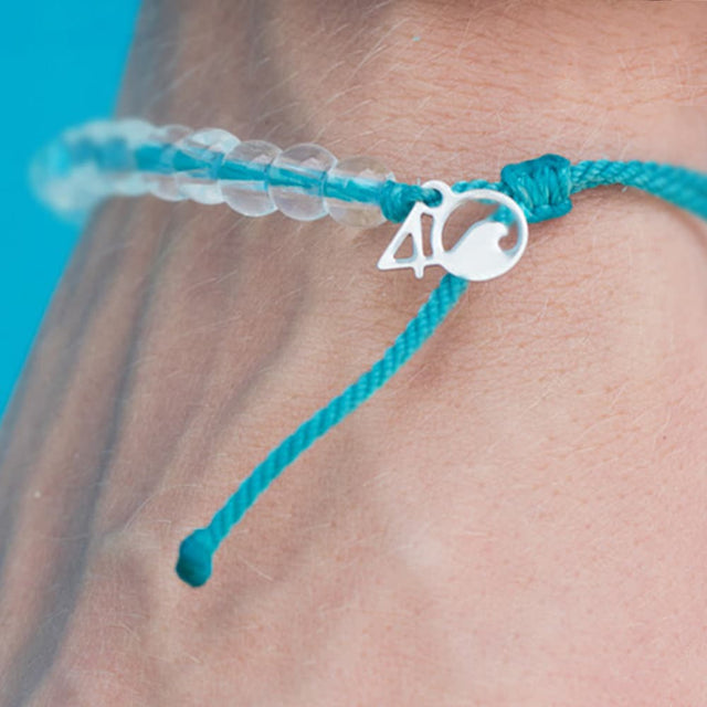 4ocean White-Sided Dolphin Beaded Bracelet on a mans wrist