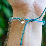 4ocean White-Sided Dolphin Beaded Bracelet on a mans wrist