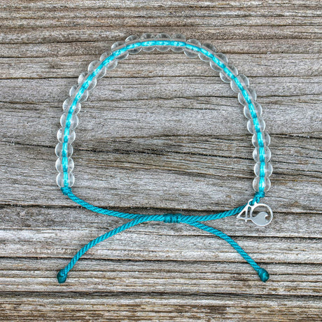4ocean White-Sided Dolphin Beaded Bracelet on a wooden plank